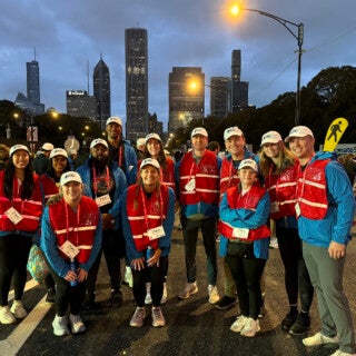 UIC students in kinesiology and exercise psychology volunteered at the Oct. 13 Chicago Marathon, to offer runners encouragement and medical help. (Photo: Michele Kerulis and Meredith Wekesser) A group of students standing at the Chicago Marathon before dawn.