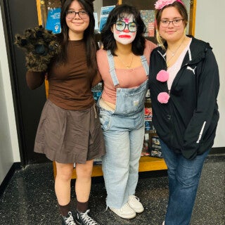 UIC students, staff and faculty celebrated Halloween in style, dressing up as everything from an avocado to a suffragette. (Photo: Jenny Fontaine/UIC) three students pose in Halloween costumes
