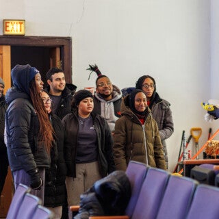For the 2025 MLK Jr. Day of Service, UIC students cleaned and picked up trash at Stone Temple Baptist Church in Lawndale. (Photo: Creative and Digital Services) students in winter coats listen to instructions in a church