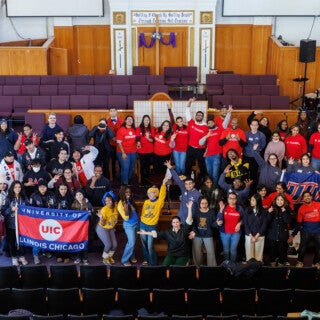 For the 2025 MLK Jr. Day of Service, UIC students cleaned and picked up trash at Stone Temple Baptist Church in Lawndale. (Photo: Creative and Digital Services) a large group of people gather for a photo in a church