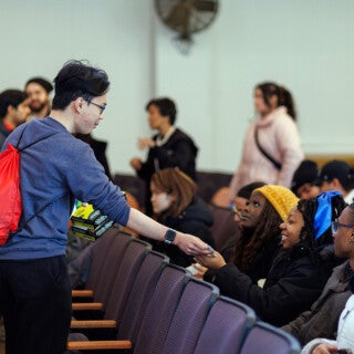For the 2025 MLK Jr. Day of Service, UIC students cleaned and picked up trash at Stone Temple Baptist Church in Lawndale. (Photo: Creative and Digital Services) A student hands out gloves before volunteer work starts at a church